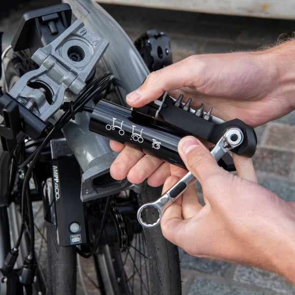A person's hands using the Brompton toolkit