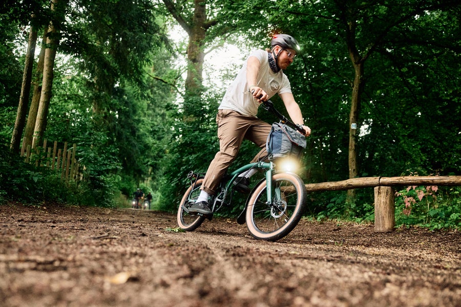 Person riding the Brompton G Line bike on muddy path