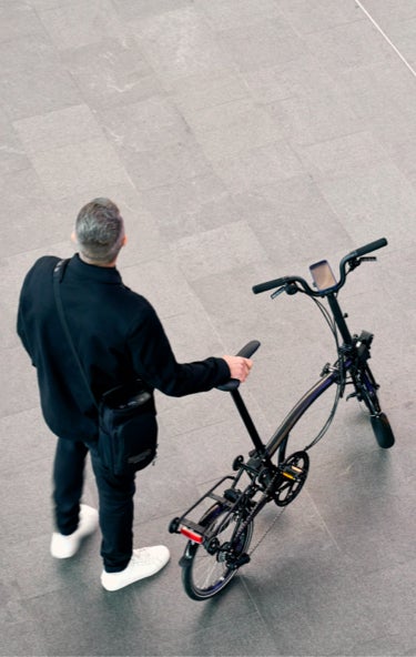 An overhead image of a man with a Brompton Electric P Line