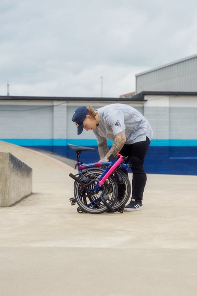 Kieran Reilly folding a Brompton bike