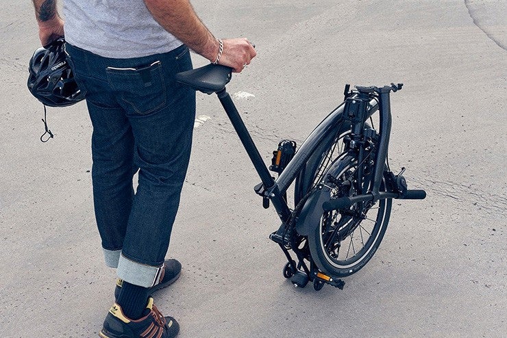 Folded Brompton bike being pushed