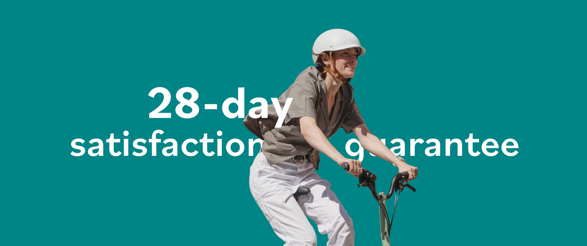 A happy woman riding a Brompton Matcha Green folding bike against a graphic green background with white graphic text "28-day satisfaction guarantee"
