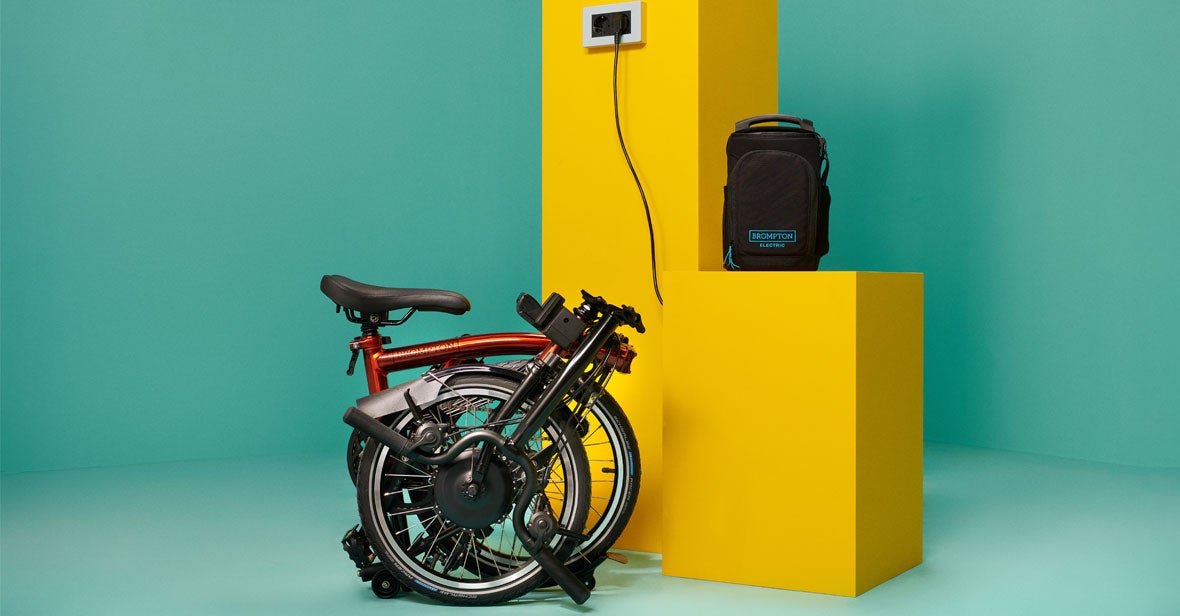 Folded brompton electric with a green background