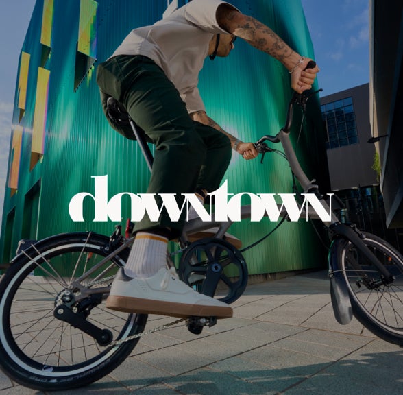 The downtown logo over an image of a person riding the Brompton T Line