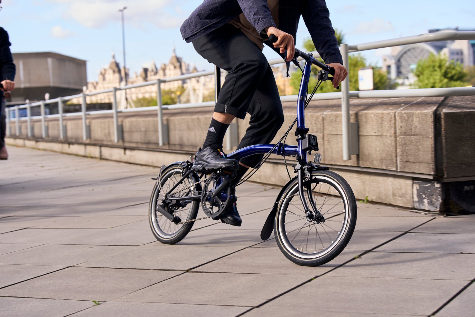 Person riding a blue Brompton P Line folding bike