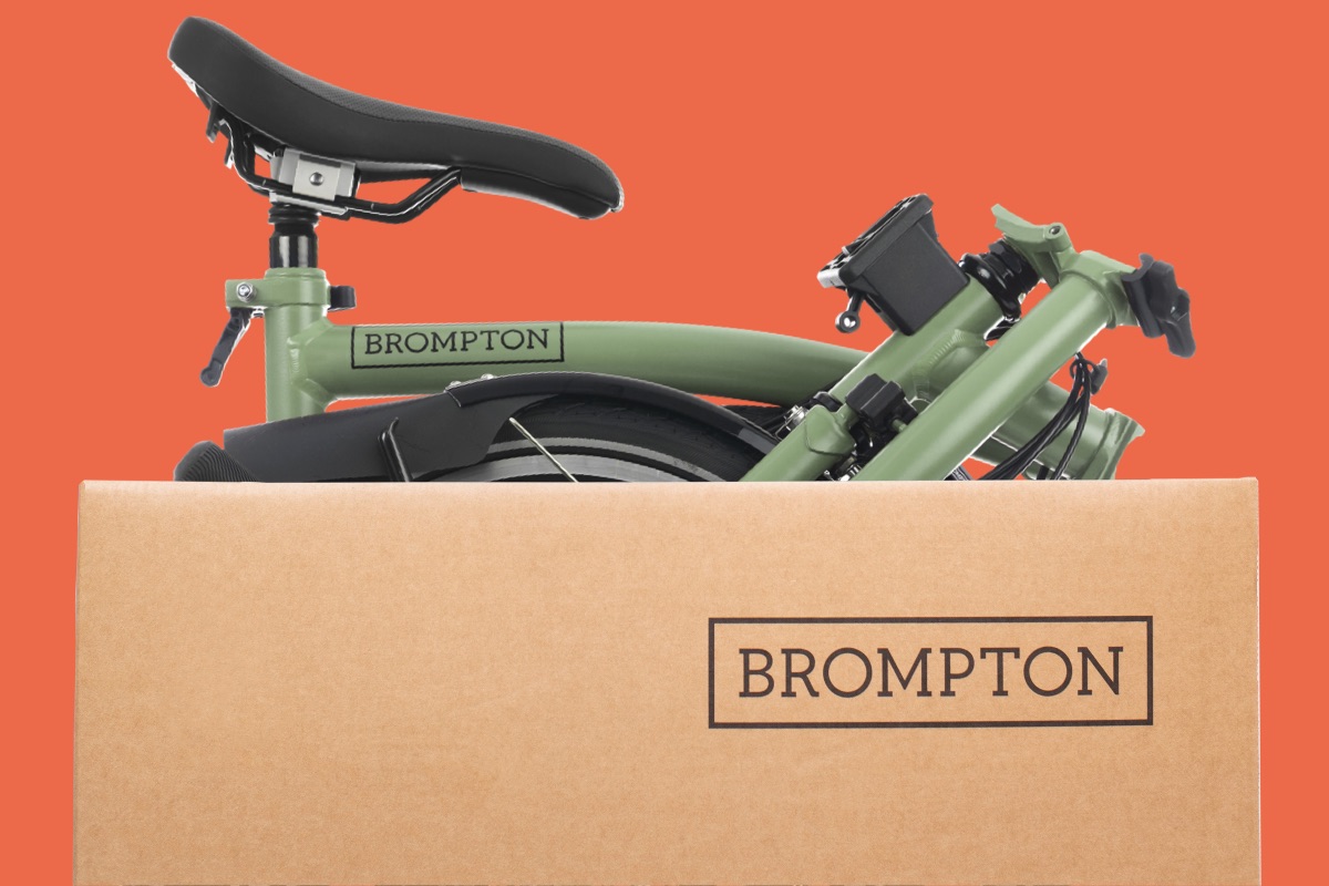 A folded Matcha Green Brompton bike in its delivery box