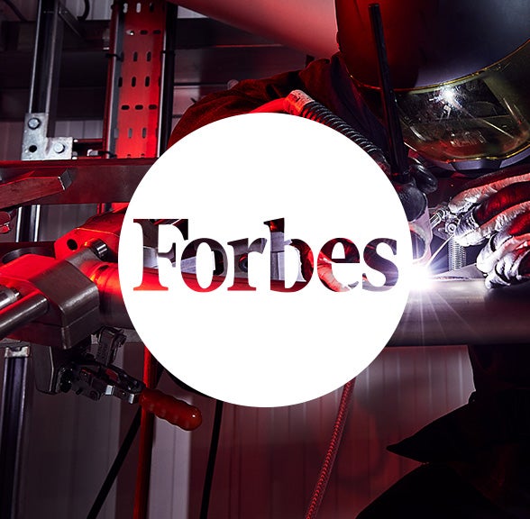 Forbes logo in white circle over Brompton bicycle