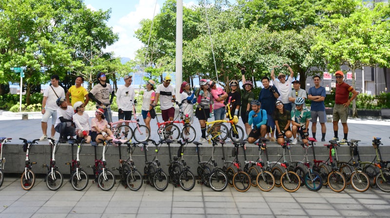 brompton team in a line with their bikes for hong kong one million  journey