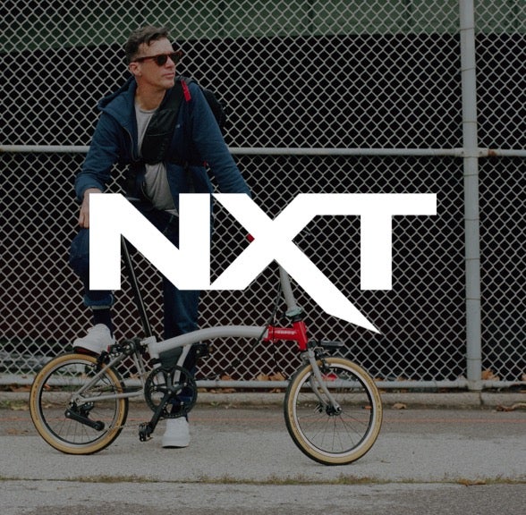 NXT logo over Brompton bicycle
