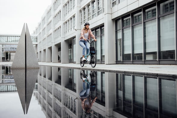 person riding brompton bike by water in munich