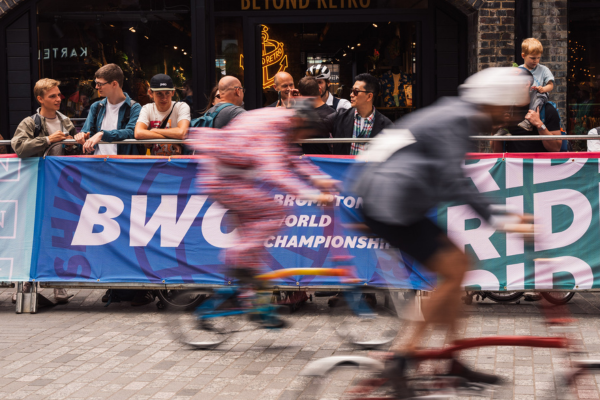 Blurred people racing on Brompton bikes