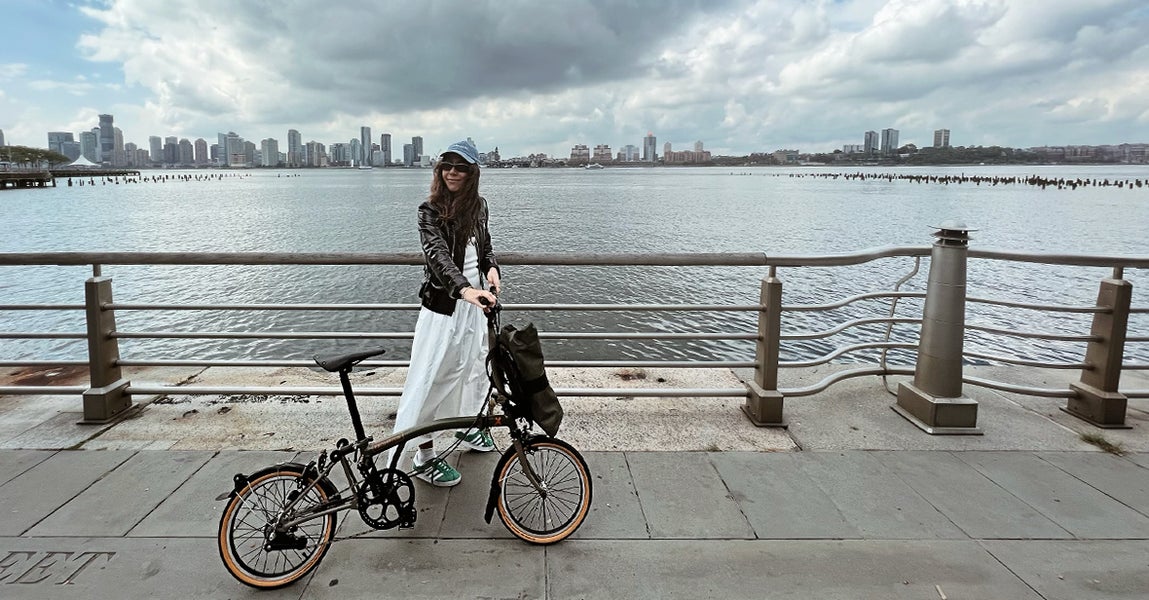 Nicole Berrie with her Brompton folding bike on the Hudson River in NYC
