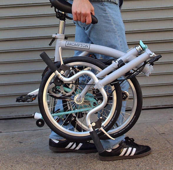 Brompton being held while folded