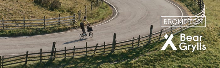 een afbeelding van de Bear Grylls Brompton-fiets op het Engelse platteland