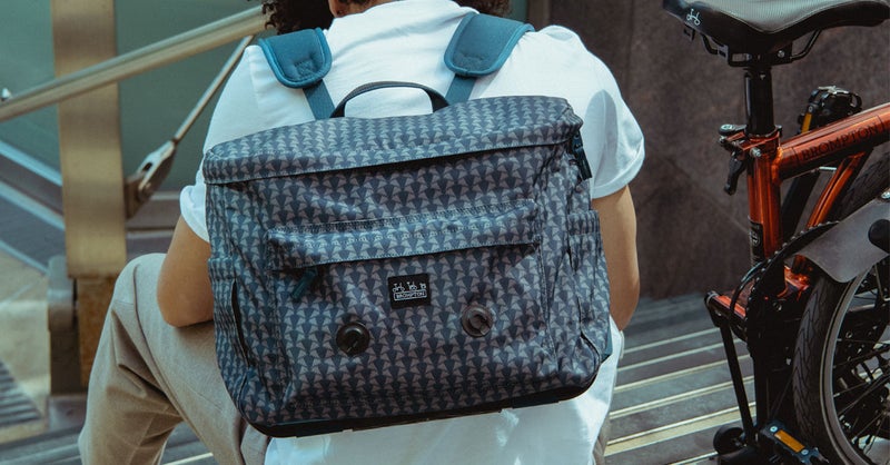 A model wearing the Brompton Backpack made with Liberty fabric in Metropolis