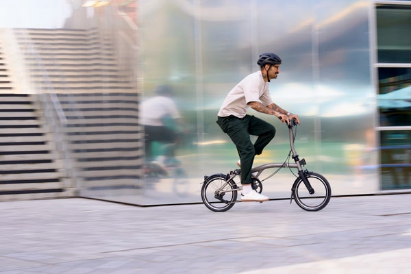 person riding a t line 12 speed uphill in the countryside