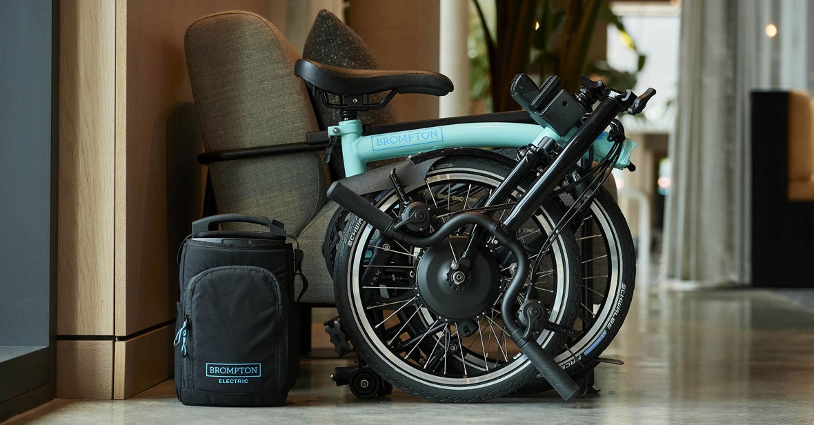 Folded brompton electric with a green background