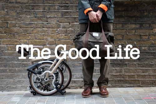 The Good Life logo over image of person in brompton barbour collaboration, and barbour brompton bike