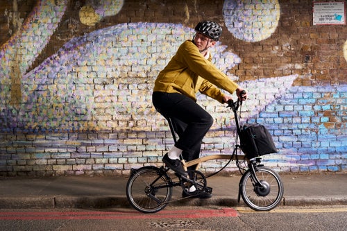 Person sat on Brompton bike