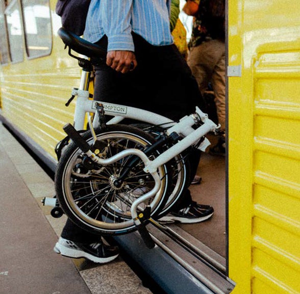 Folded Brompton being carried onto train
