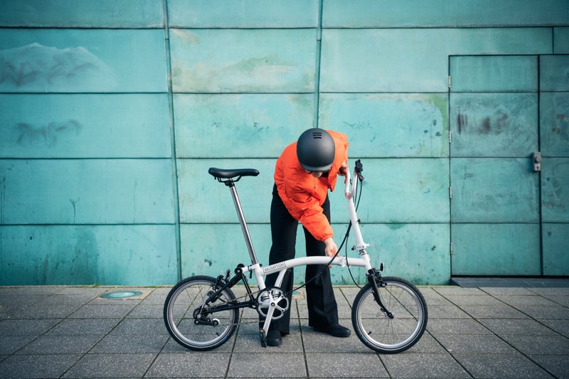 a line brompton folding image in front of blue wall