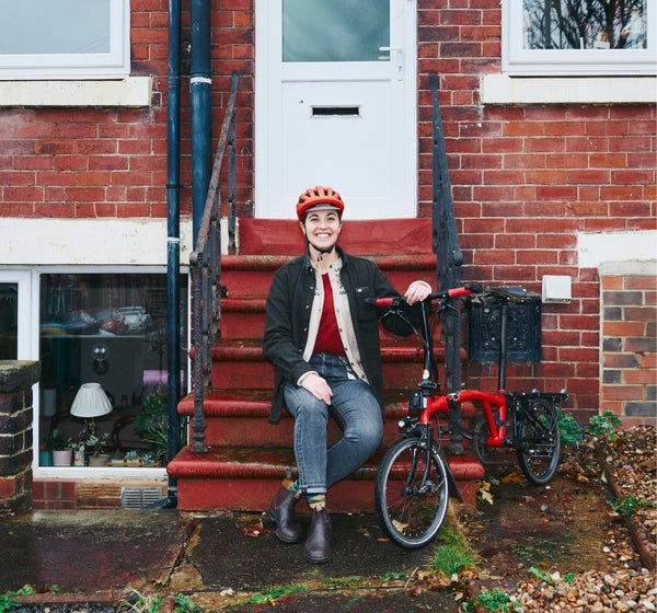 A photograph of Vanessa with her Brompton outside of her flat