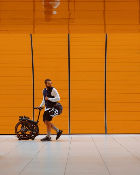 Person stood with Brompton G Line bike