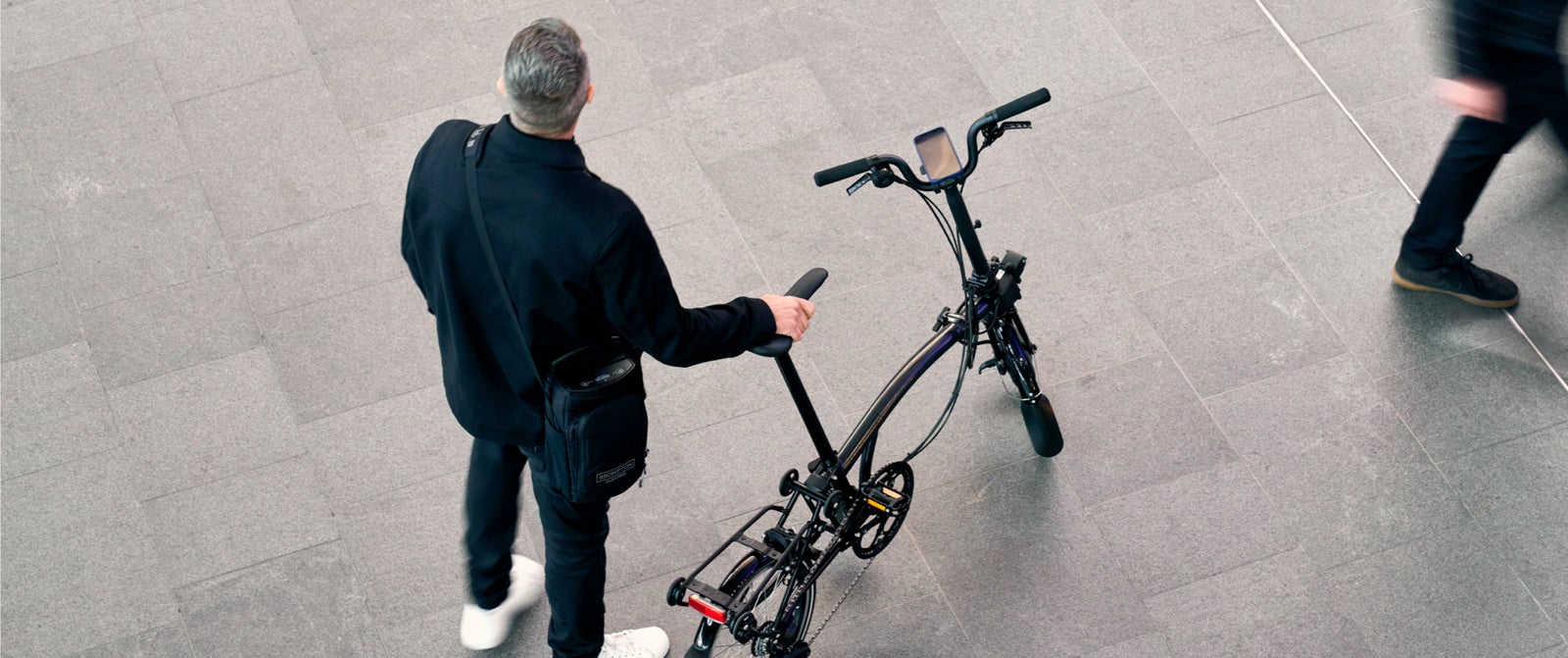 An overhead image of a man with a Brompton Electric P Line