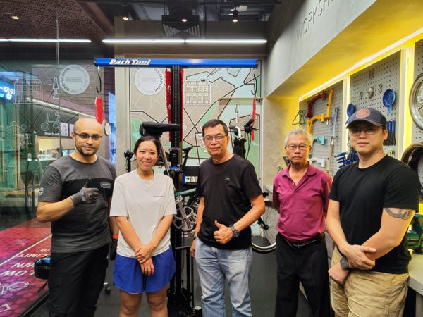Five people stood in the Singapore Junction workshop