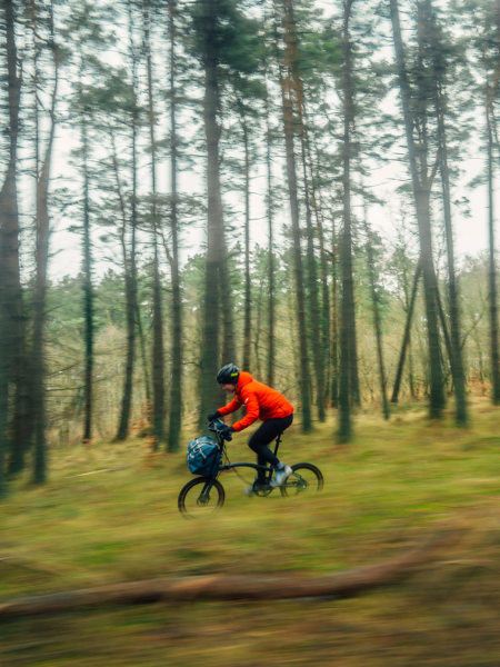 Two riders on G Line bikes in a forest