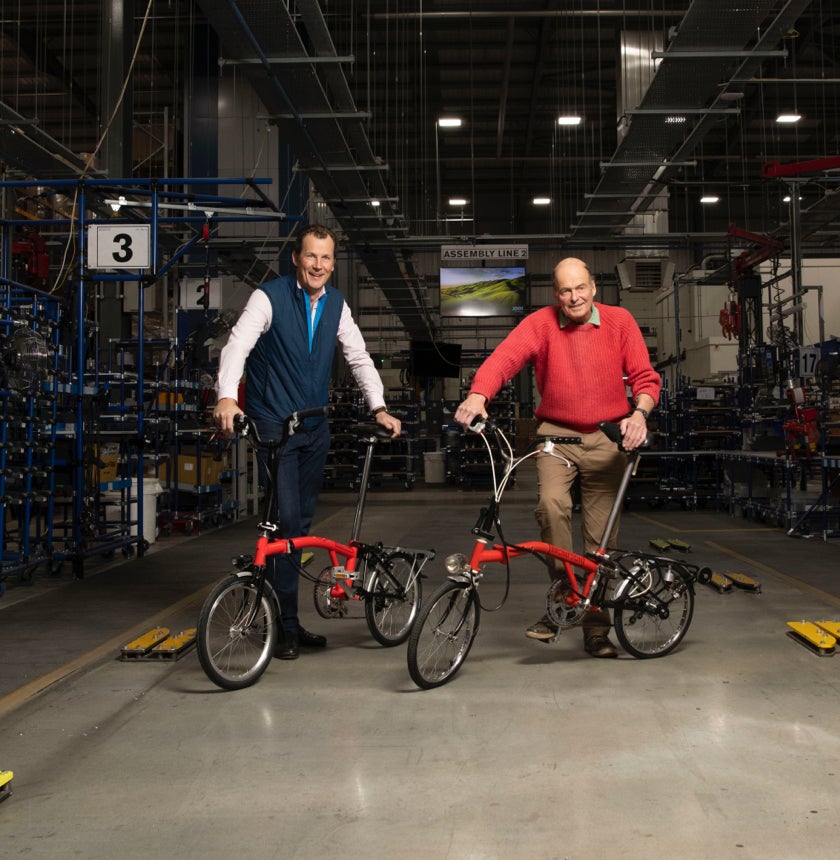 Brompton CEO Will Butler-Adams and Founder Andrew Ritchie posing with Bromptons in the Greenford factory