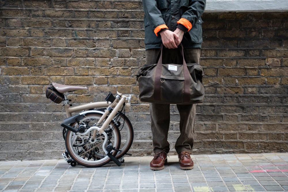 A model posing with the Barbour x Brompton bag