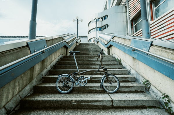 a brompton bike leaning on stairs