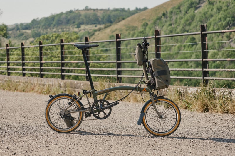 brompton bear grylls collaboration bike in front of a field