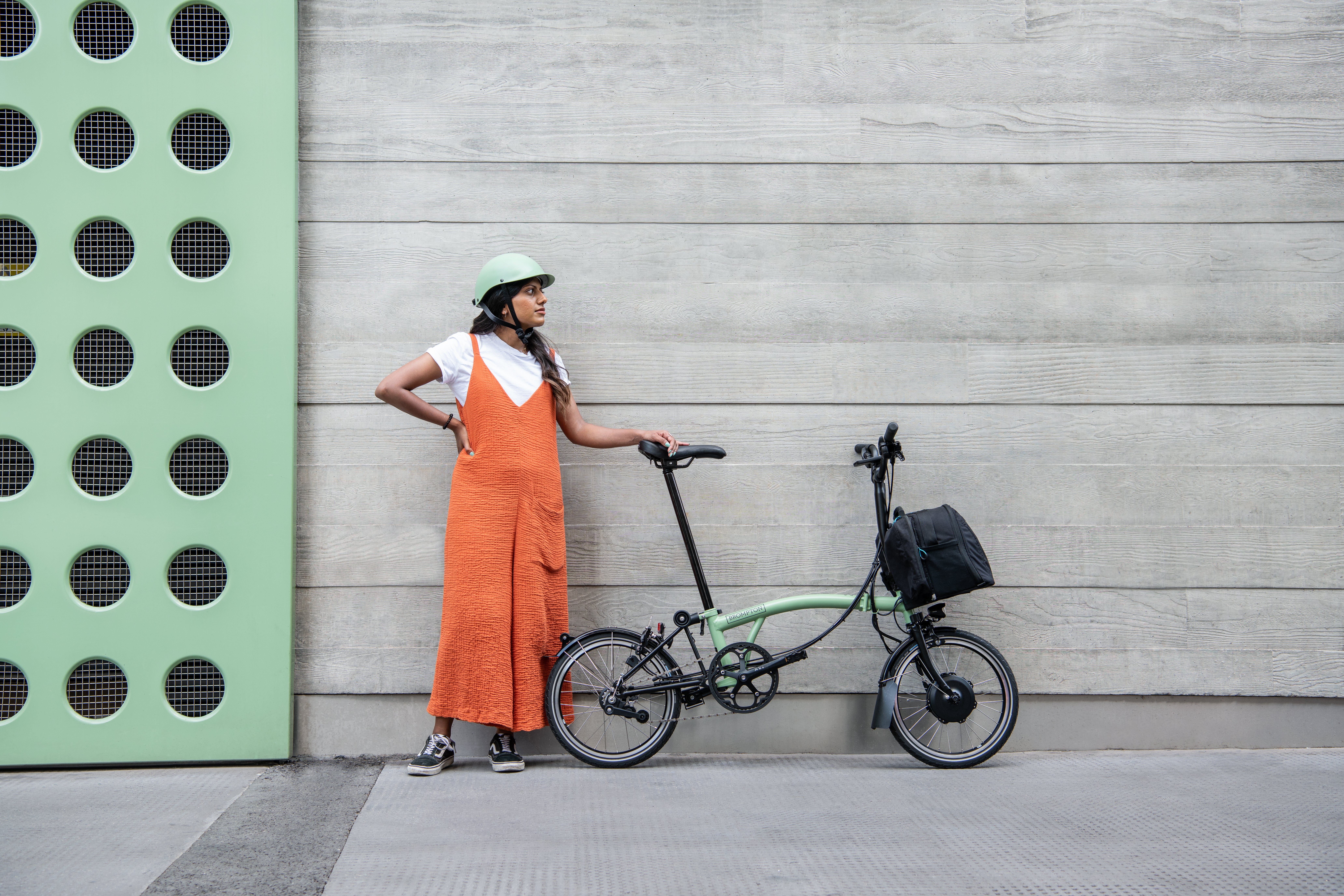 Person stood next to a matcha green Brompton bike