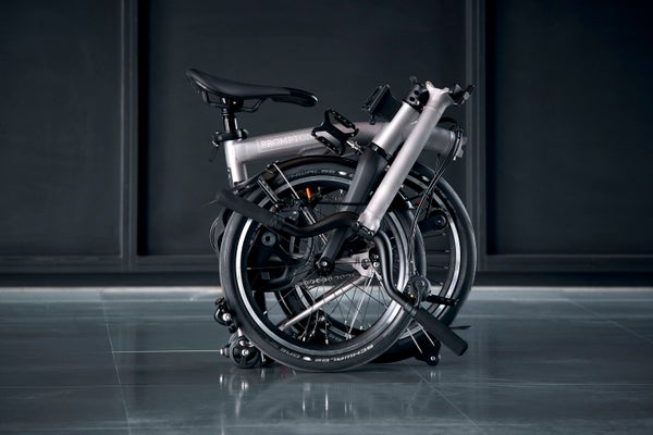 a studio shot of a folded brompton t line bike