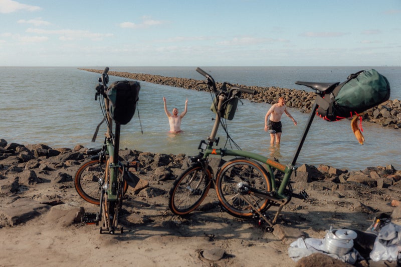 german roamers with bear grylls brompton bikes in the sea