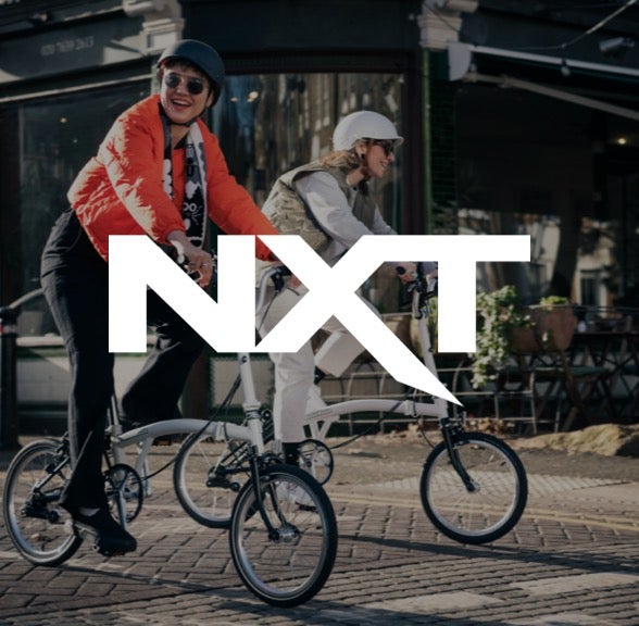 NXT logo over Brompton bicycle