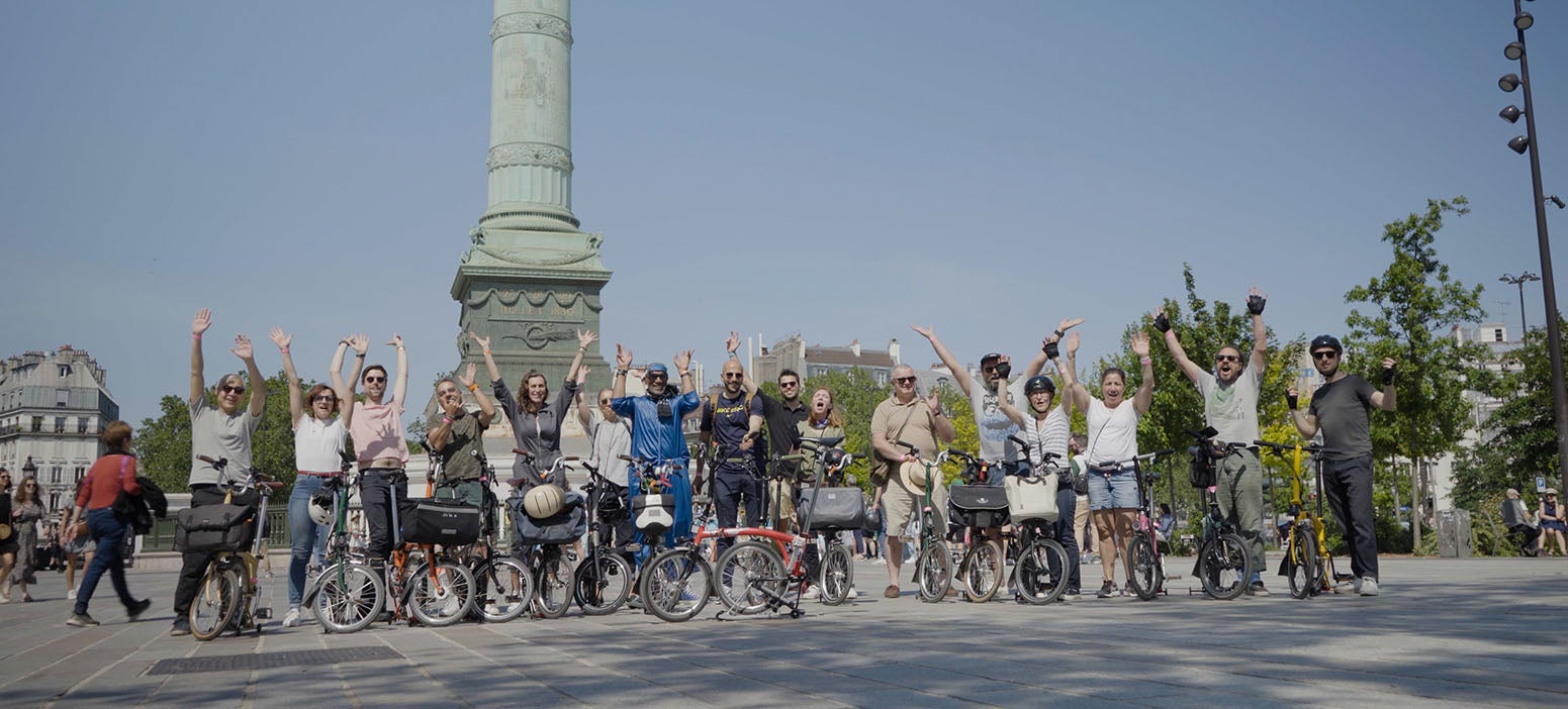 A group of Brompton owners posing happily after the One Millionth ride out in Paris, France