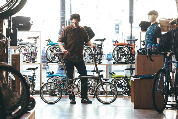 person in a brompton junction store taking a test ride