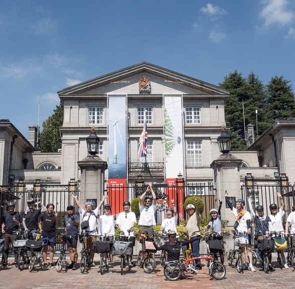 The Japanese Brompton community posing in front of the British Embassy in Tokyo, Japan