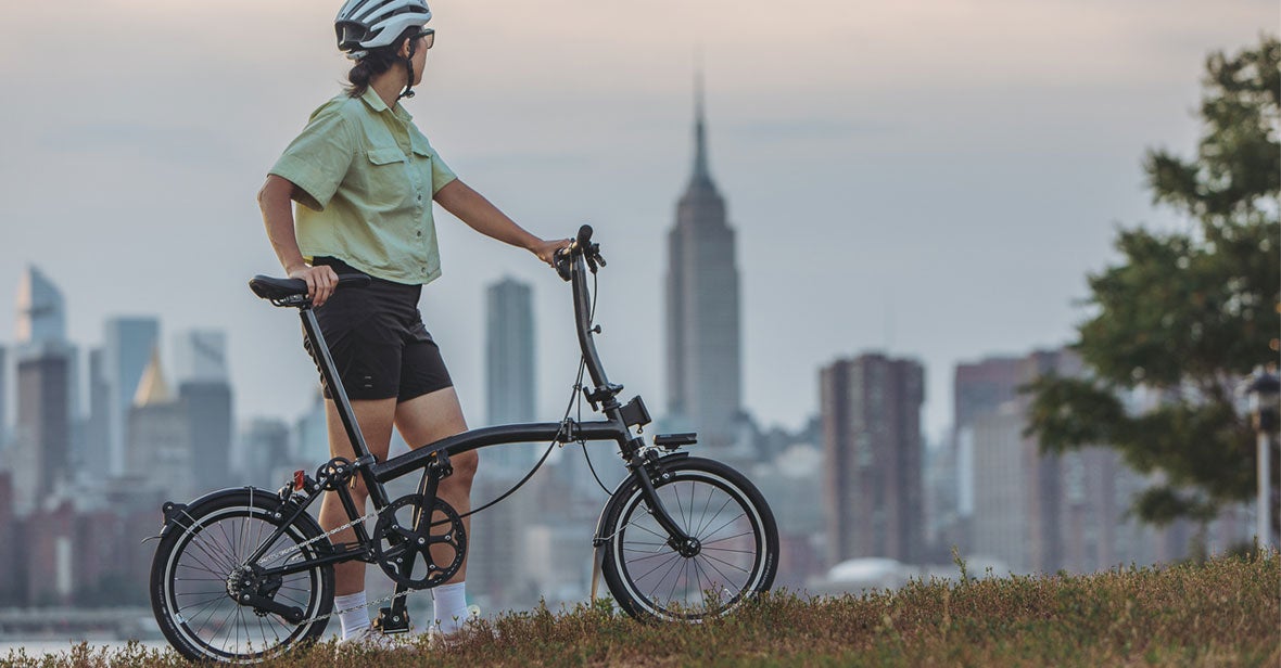 Woman with Brompton against new york skyline
