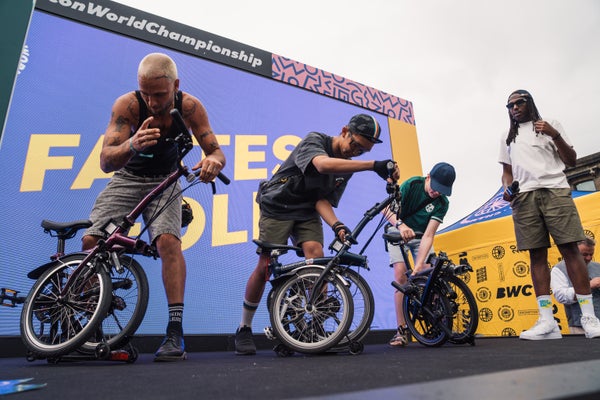 People unfolding Bromptons