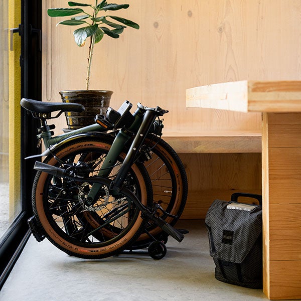 Folded G Line Brompton next to a table