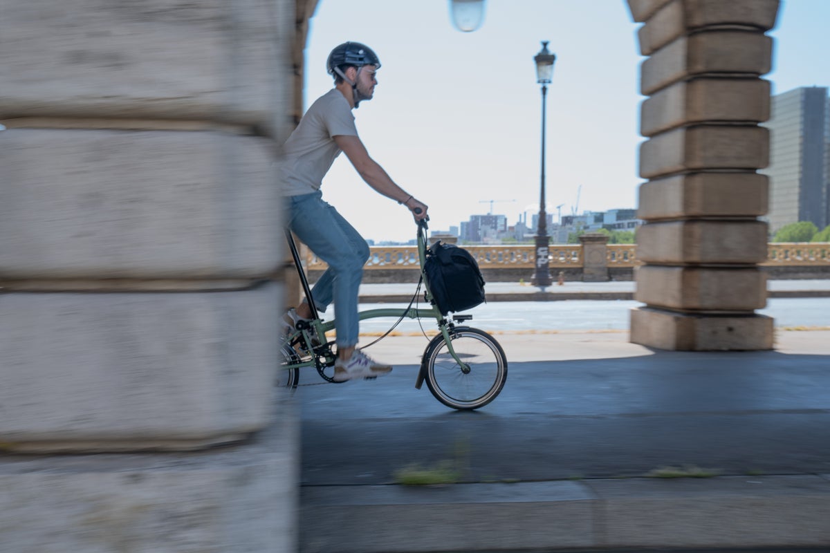 person cycling brompton bike in Paris