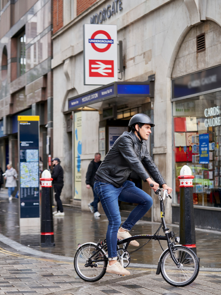 Person riding past a London train and tube station