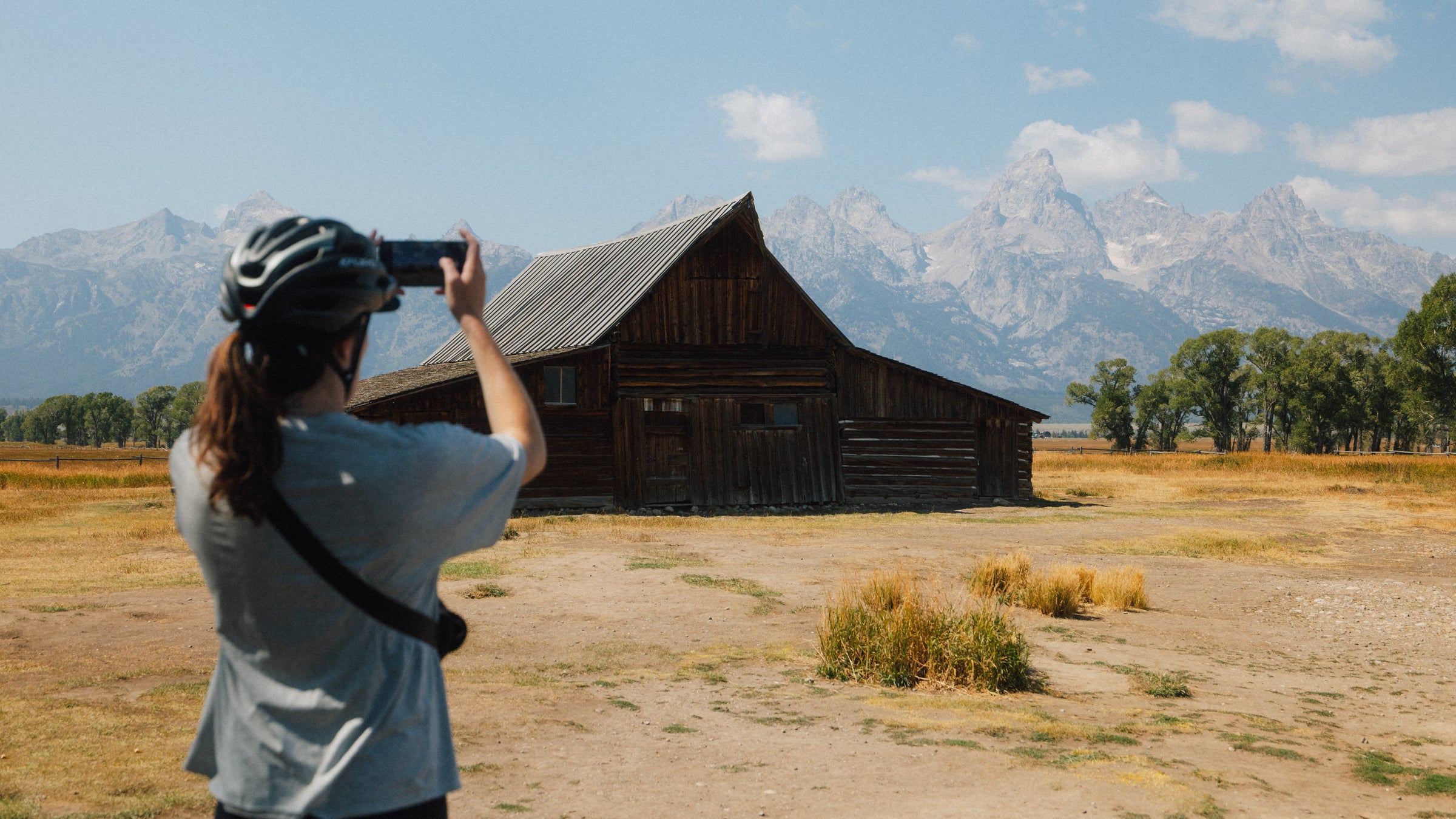 A guest takes a photo of the famous Moulton Barn in Jackson Hole, Wyoming.
