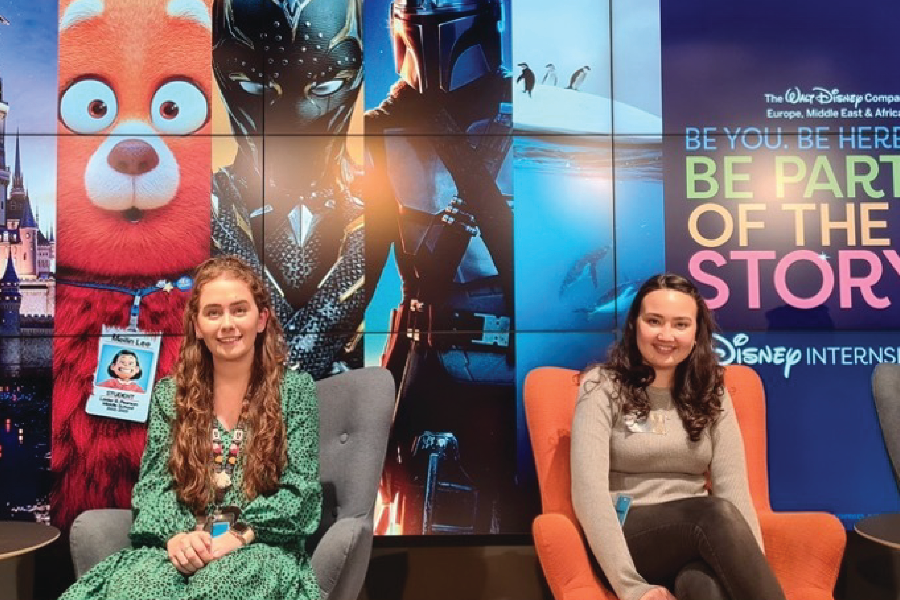 Four UK Interns smiling in front of a Be Part of the Story screen