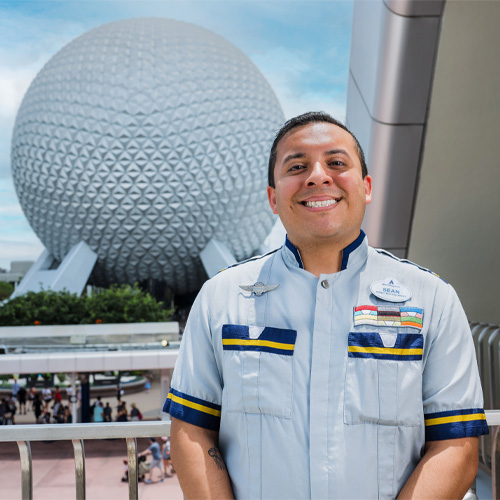 Male cast member posing in front of Epcot