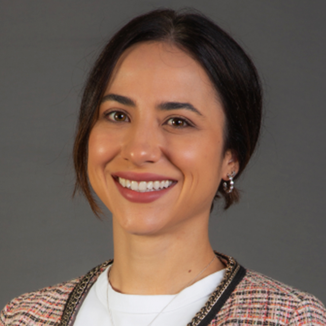 Head of Talent Acquisition The Walt Disney Company LATAM, Bianca wearing a white shirt and colorful jacket smiling with brown hair tied back